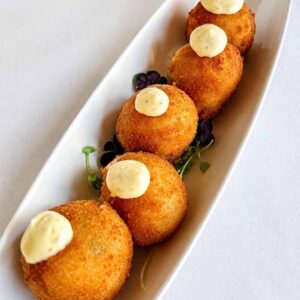 croquettes cooked on a plate with sauce
